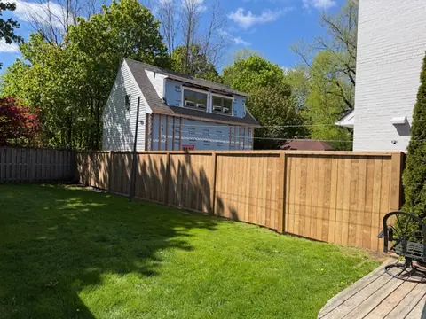 Backyard wood privacy fence project in Halifax Bright backyard wood privacy fence with a green lawn in Halifax