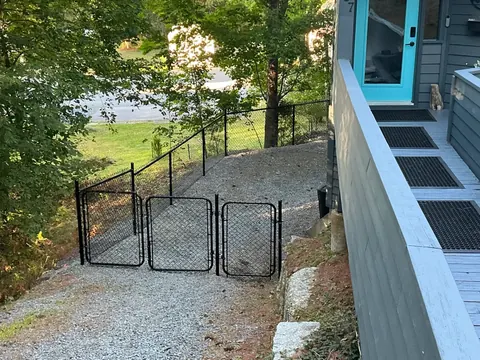 Chain-link gates at a gravel entrance