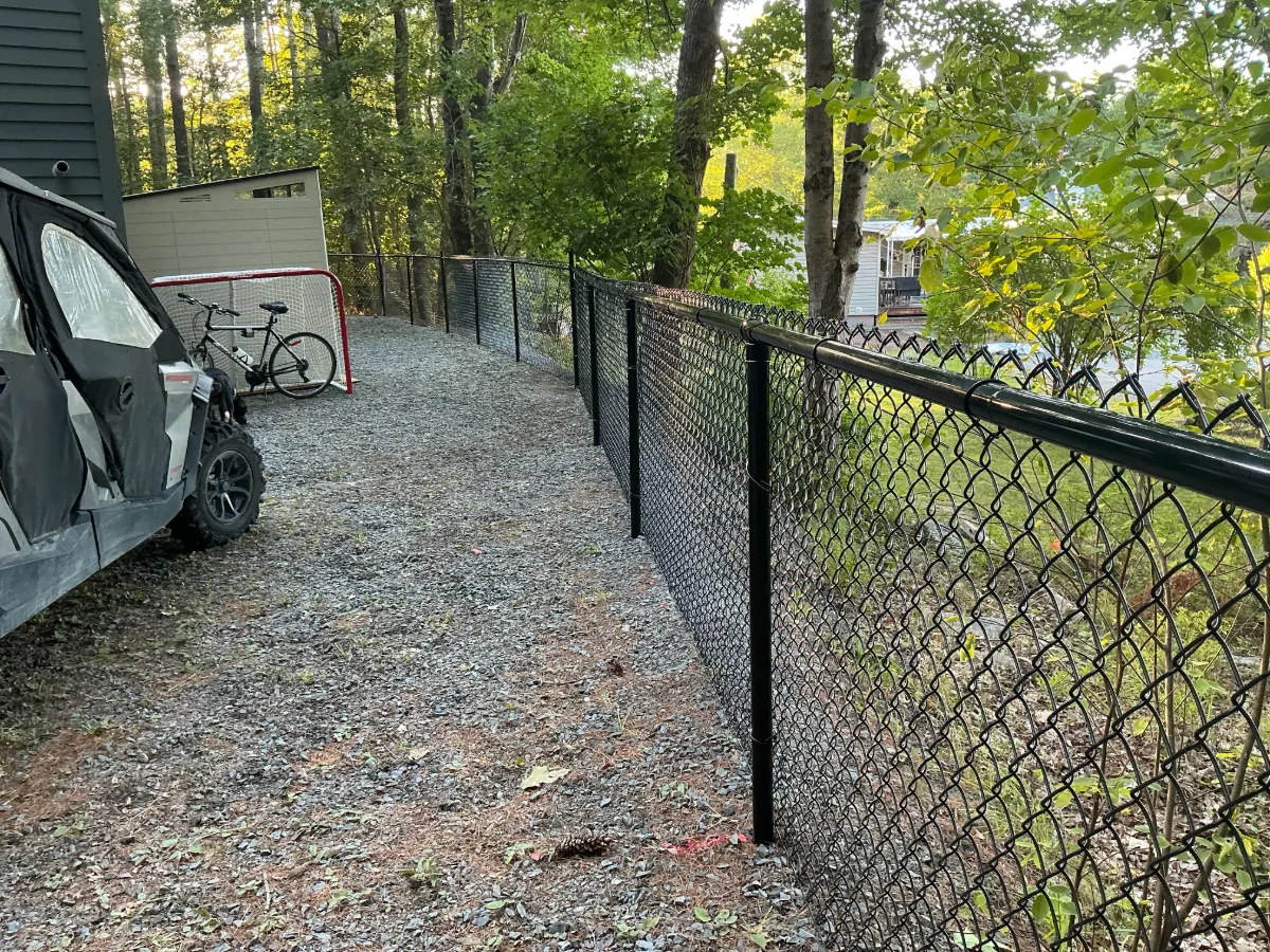 Black chain-link fence along a gravel path