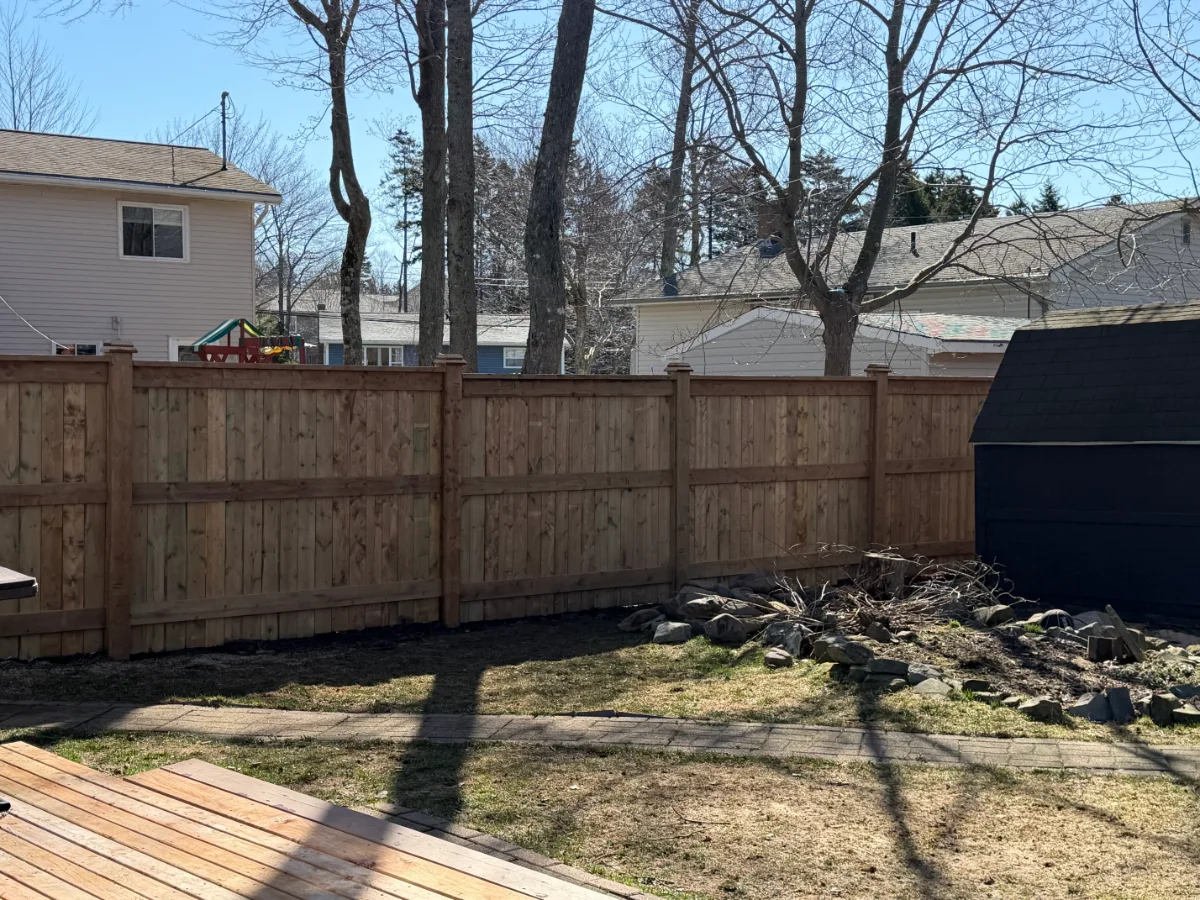 Finished wood fence across a backyard