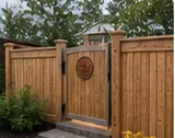 Black ornamental gate with stone posts